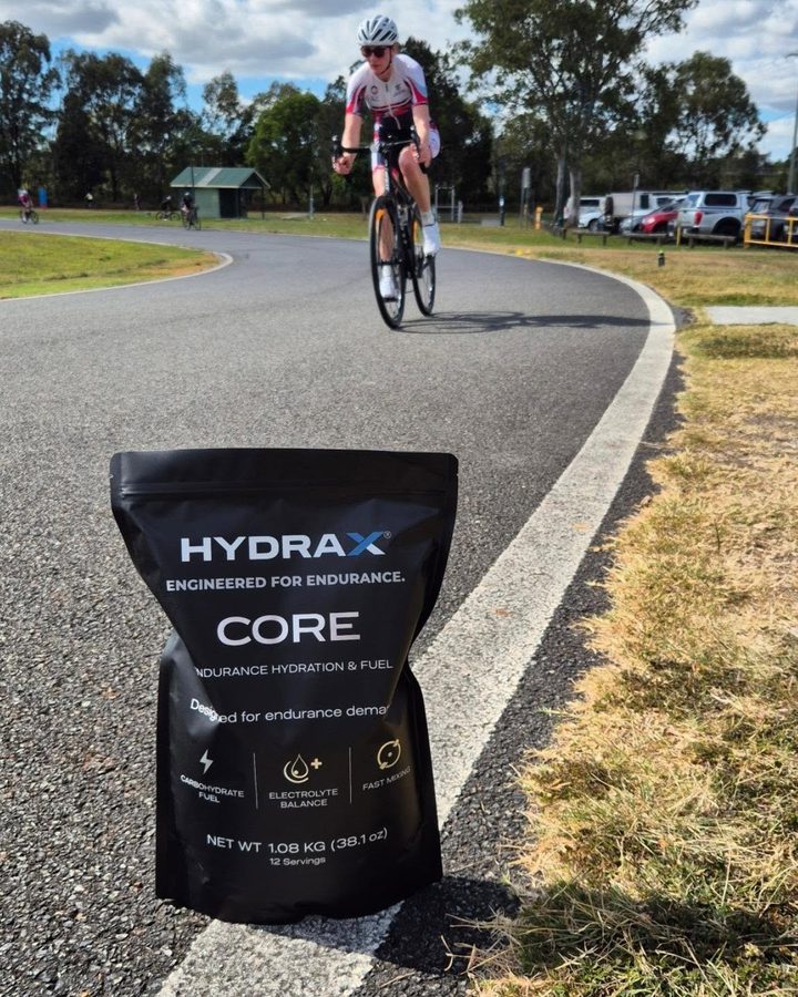 HYDRAX CORE pouch trackside while a triathlete rides past at a squad session