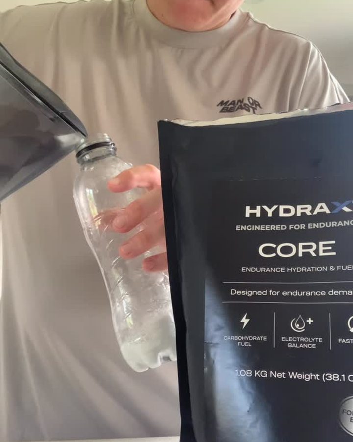 Athlete filling a bottle from a HYDRAX CORE pouch