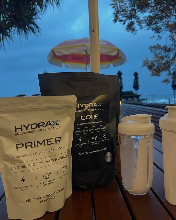 HYDRAX PRIMER and CORE on a cafe table at sunrise